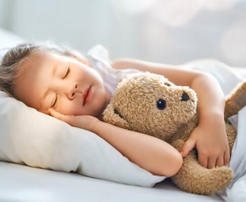 little gir resting with her teddy bear