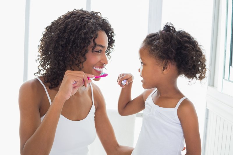 parent and child brushing their teeth