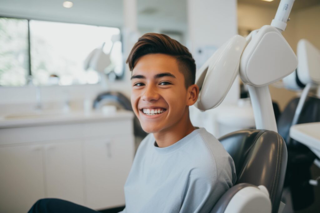 Teen smiling while sitting in treatment chair